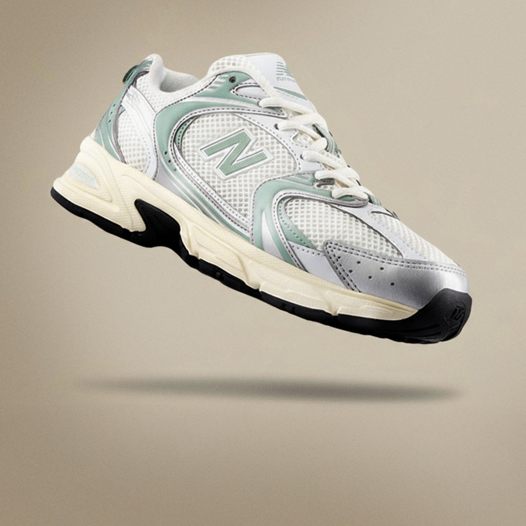 NEW BALANCE 530. The it-girl shoe of 2025. Featuring a new colourway in metallic silver and pale green, the 530 applies a contemporary, everyday style outlook to a performance-minded design. SHOP 530