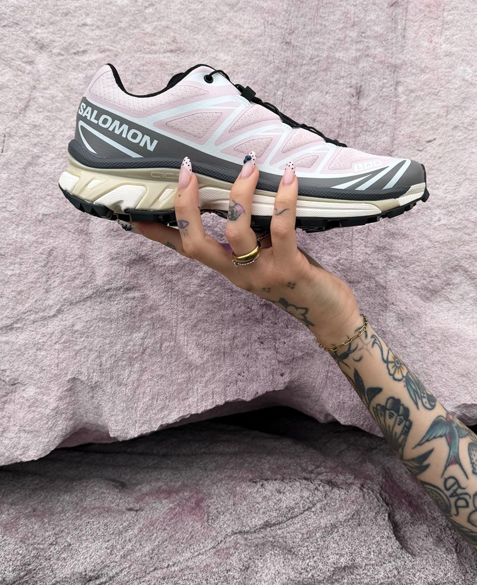 SOFT HUE, STRONG MOVE. The iconic Salomon XT‑6 lands in a soft baby pink colourway with trail DNA SHOP SALOMON