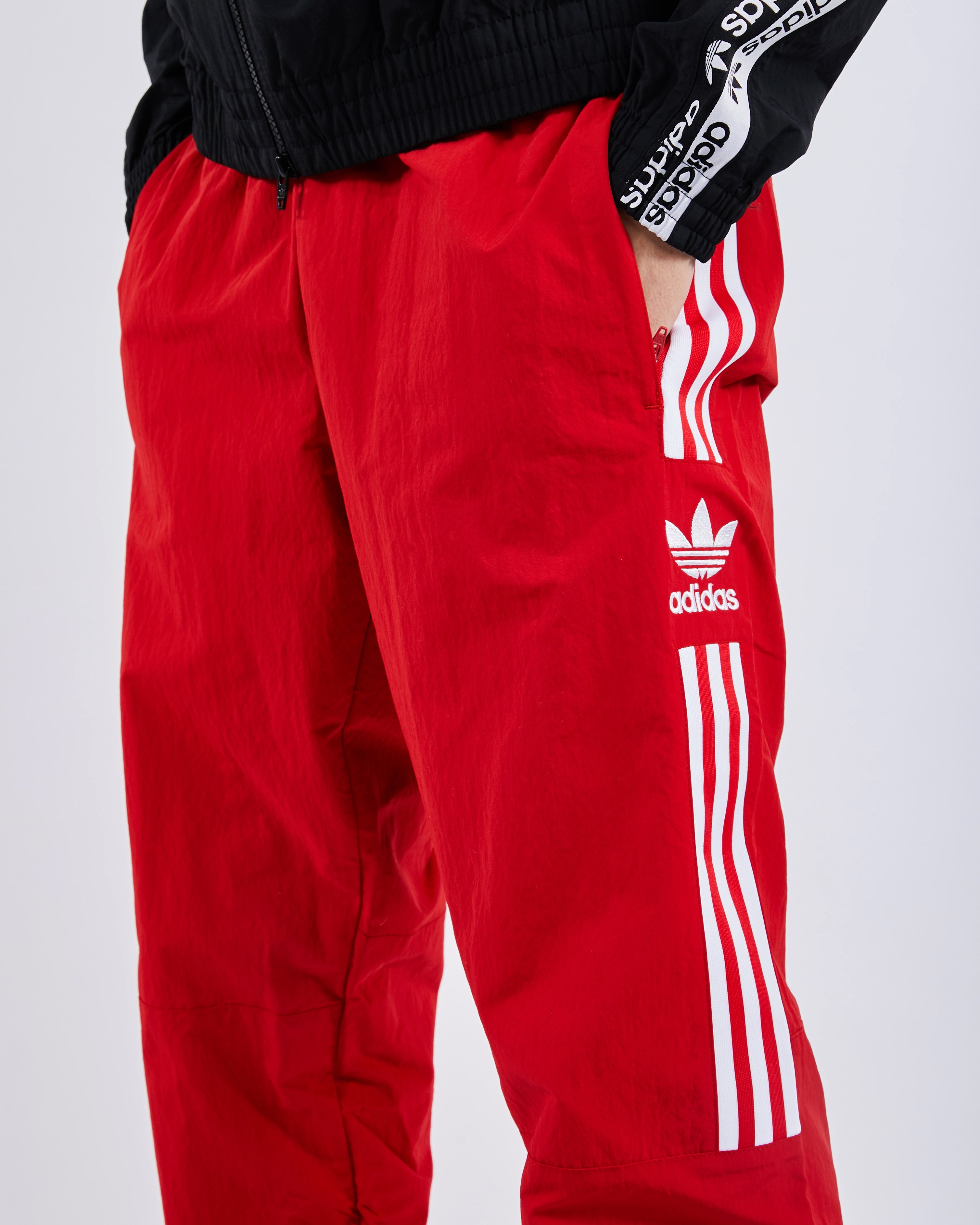 adidas originals adicolor locked up logo track pants in red